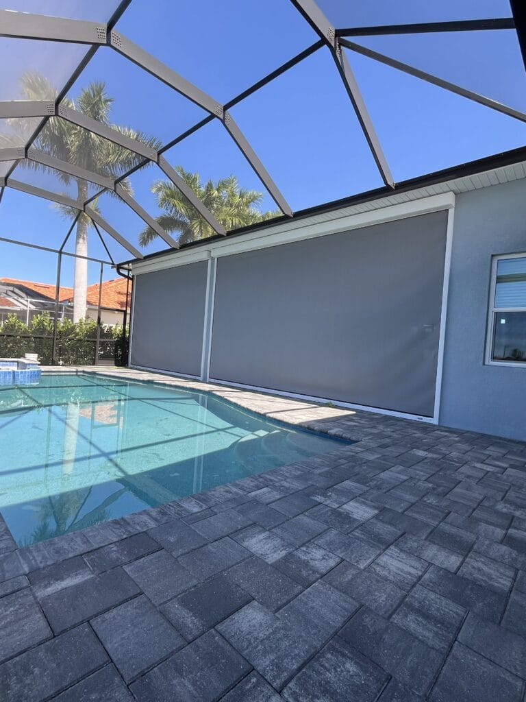 Motorized hurricane screen across a large poolside lanai opening