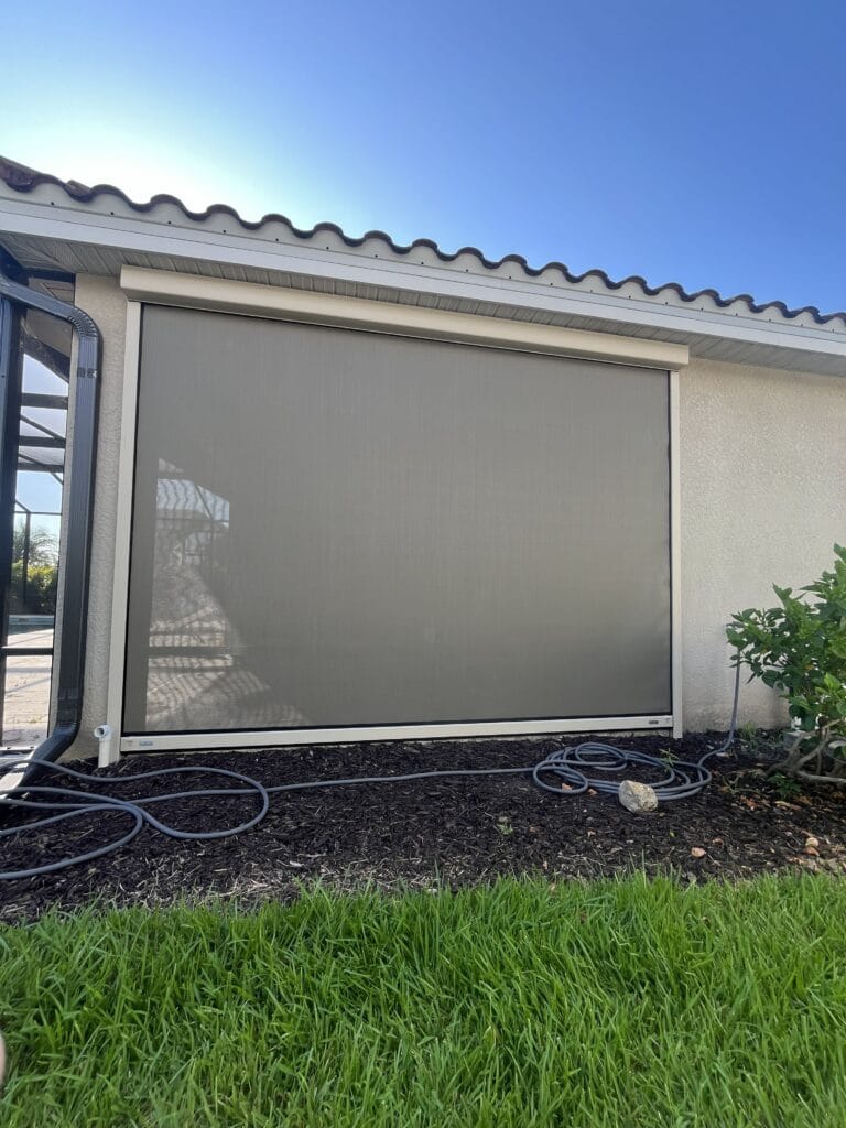 Exterior motorized hurricane screen installed on a covered lanai