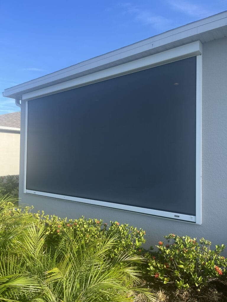 Retractable hurricane screen covering a large residential patio opening