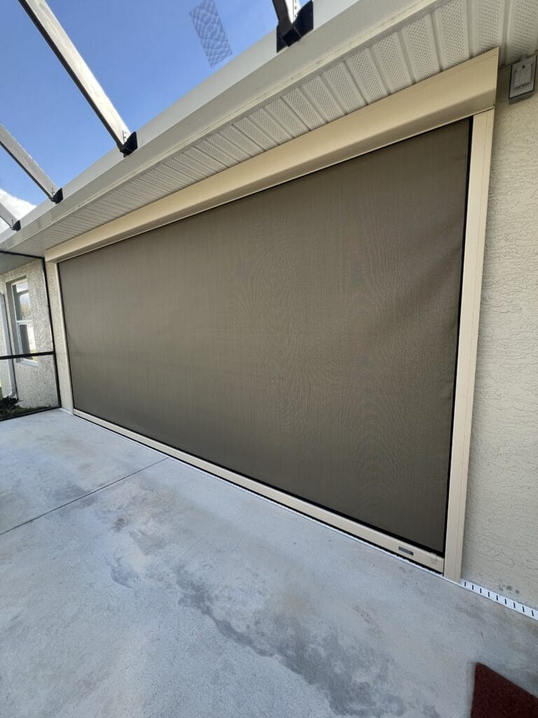 Motorized hurricane screen protecting a large outdoor patio opening