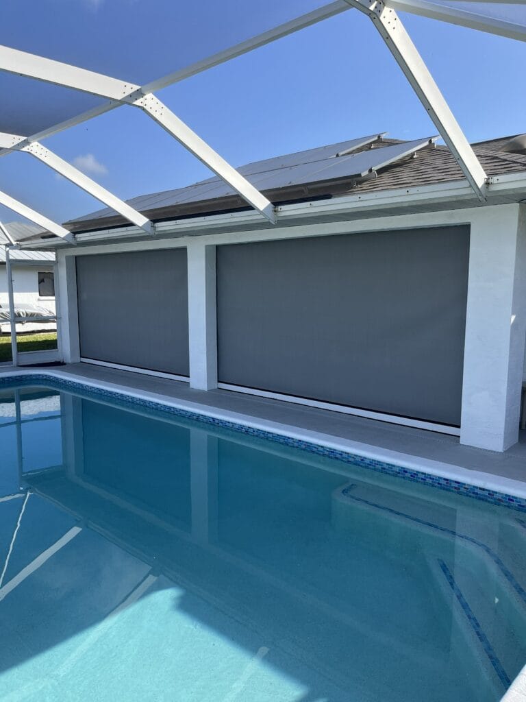 Large hurricane screen protecting a residential pool and lanai