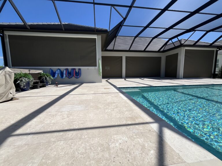 Motorized hurricane screen across a large poolside lanai closed