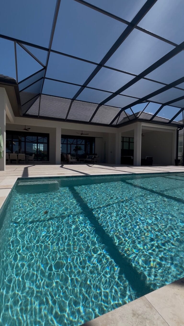 Motorized hurricane screen across a large poolside lanai open