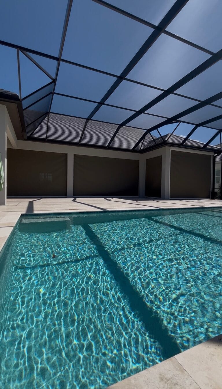 Motorized hurricane screen across a large poolside lanai closed