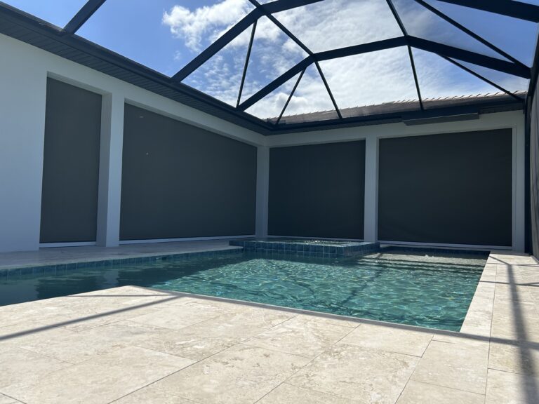 Motorized hurricane screen across a large poolside lanai closed
