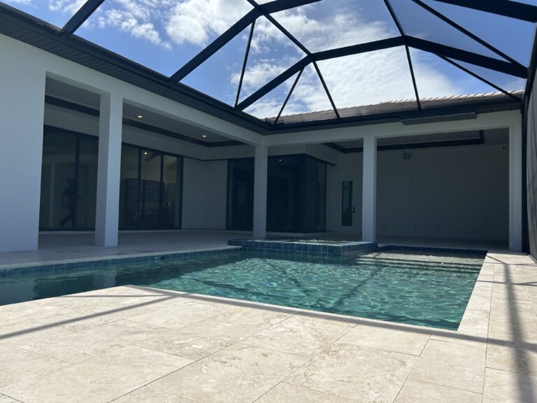 Motorized hurricane screen across a large poolside lanai open